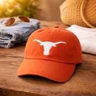 Texas Longhorns hat styled with casual game day outfit including denim shorts and sunglasses.